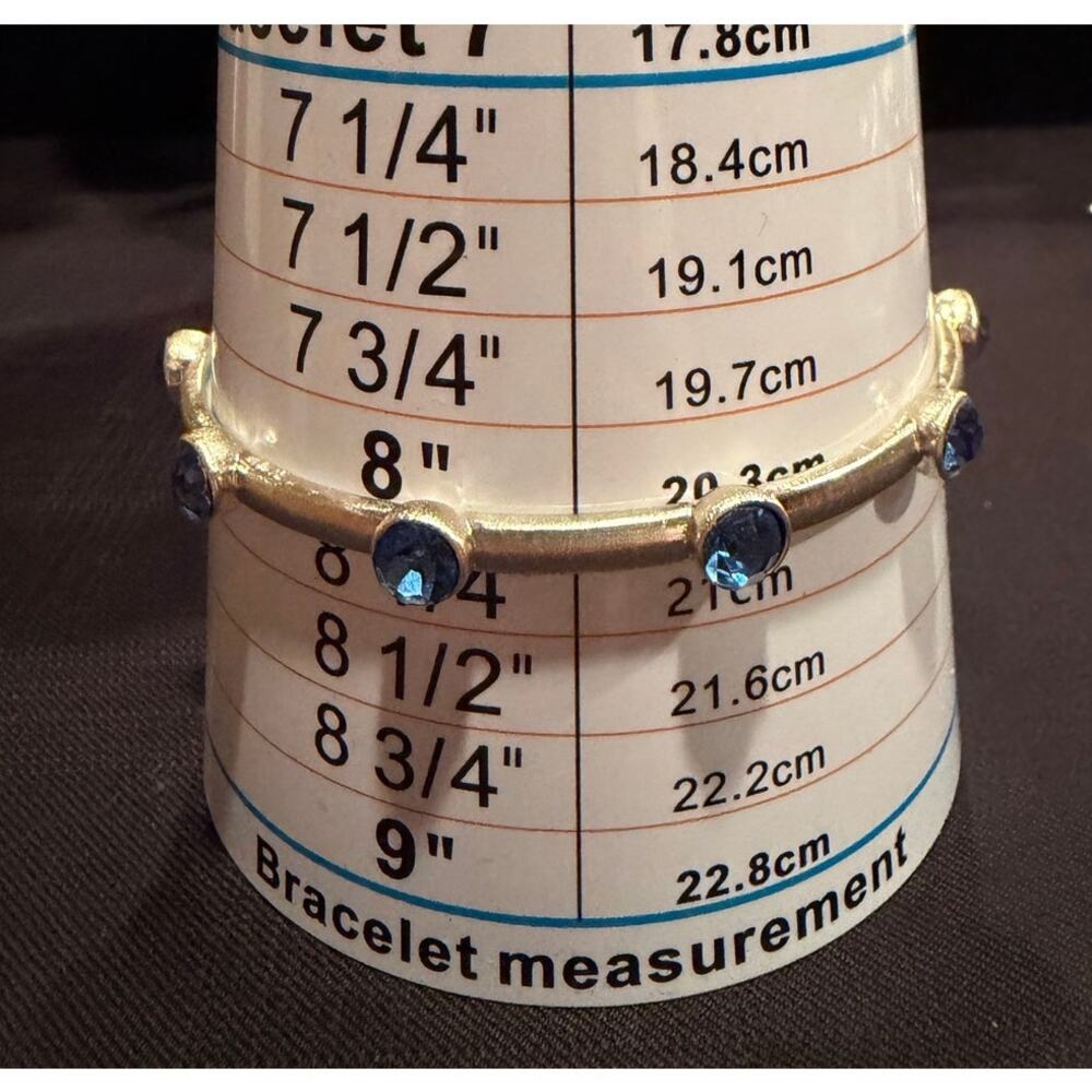 Silver-tone bangle bracelet 8” bezel-set blue sapphire-colored gemstones